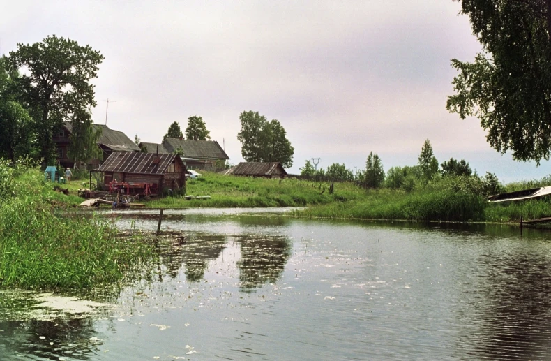 small wooden houses sitting next to a river