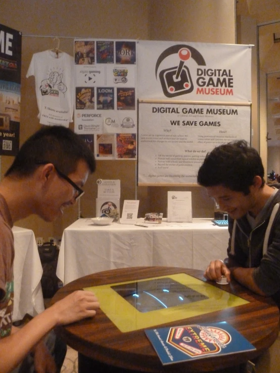 two men in a room playing with a game board