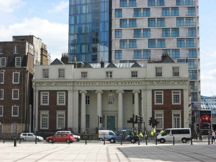 the front of a big building with people in it