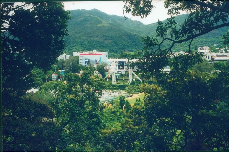 the view from behind some trees and buildings