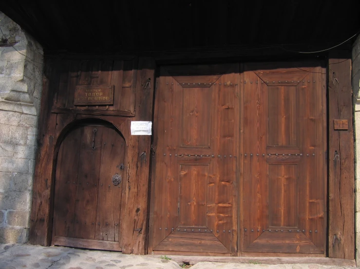 this large wooden door is in the front of a building