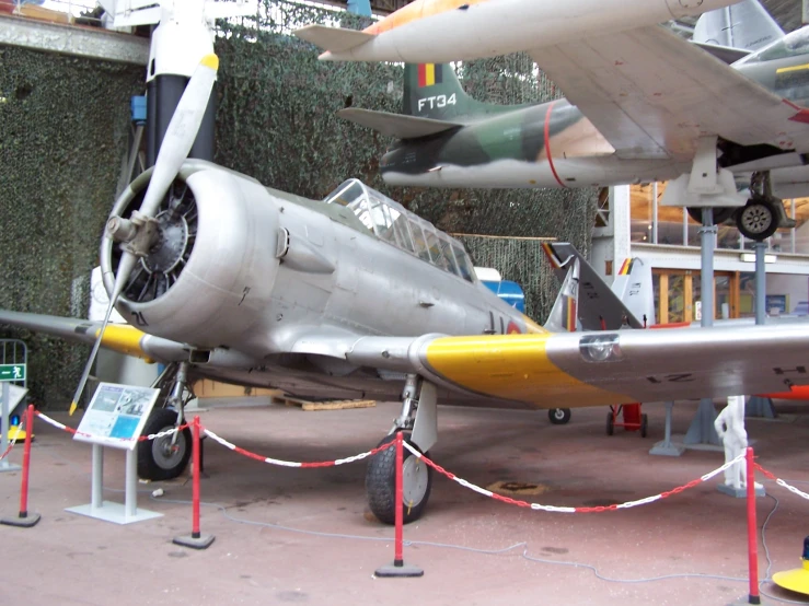 a plane is on display next to a wire fence