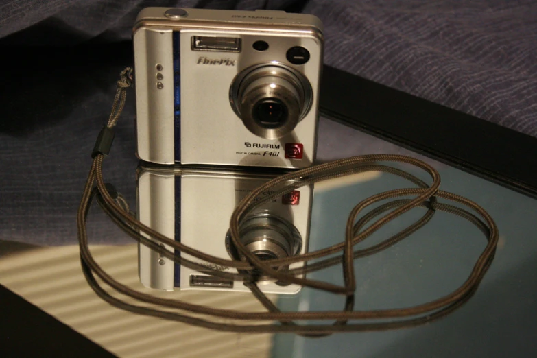 a digital camera is shown sitting next to another electronic device