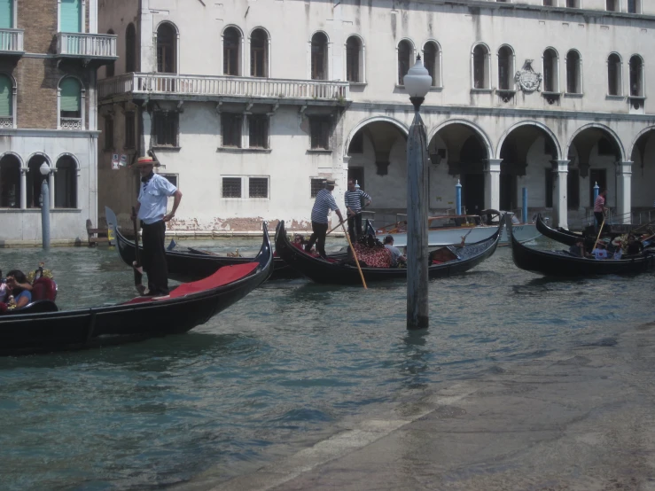 the gondolas of three people are tied to poles