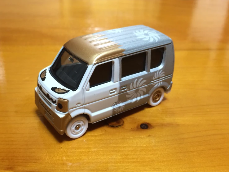 a model van sitting on top of a wooden floor