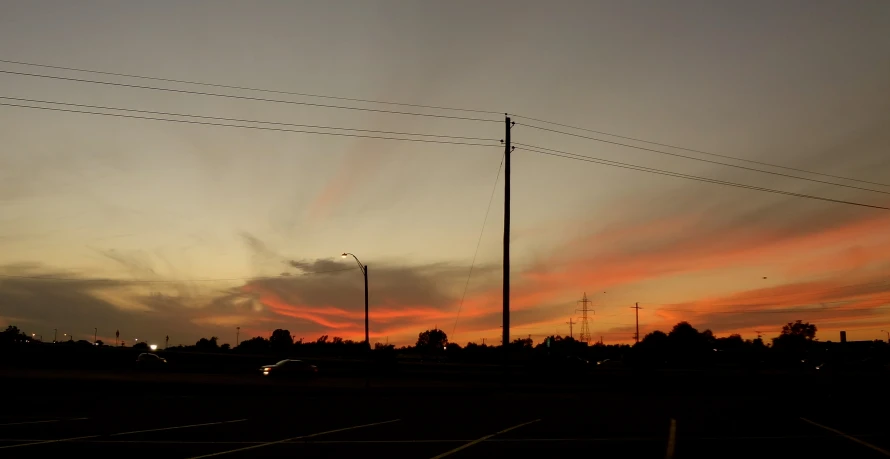 a beautiful view of the sky and the setting sun from a distance