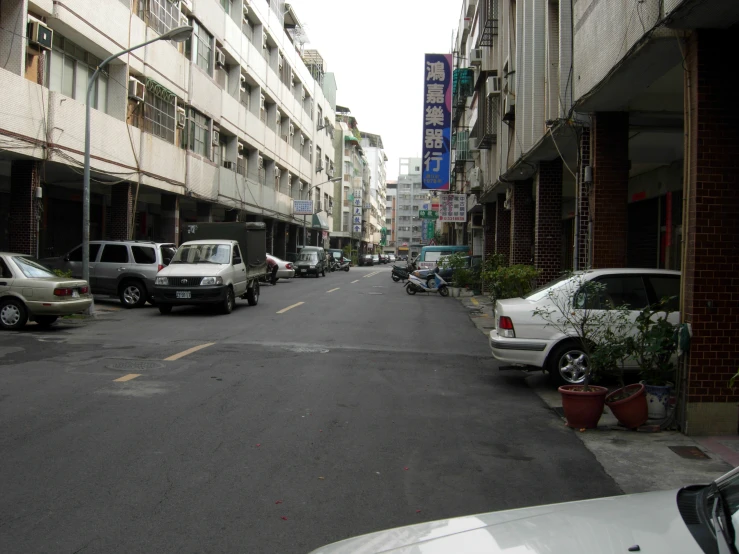 cars are parked along the street on either side of each other