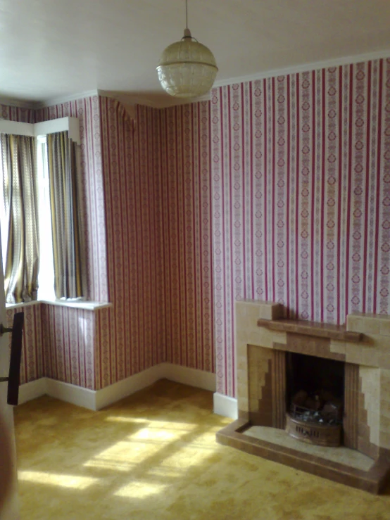 a bedroom with a fireplace and wall paper in it