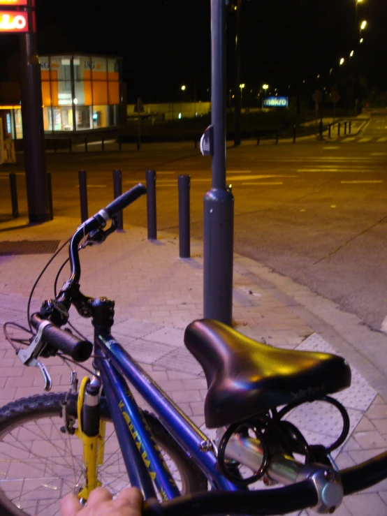 a bicycle on the side of the street with another bike attached to it