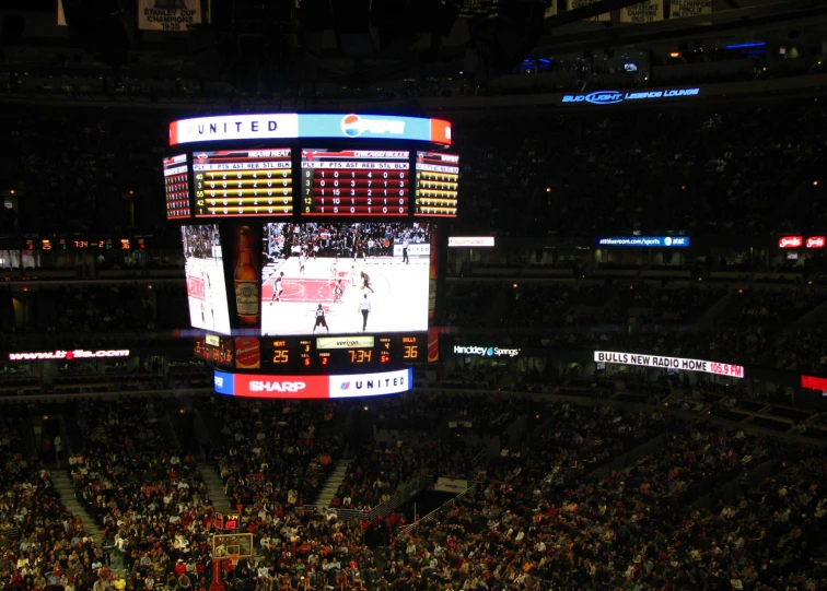 a large basketball court filled with people playing basketball