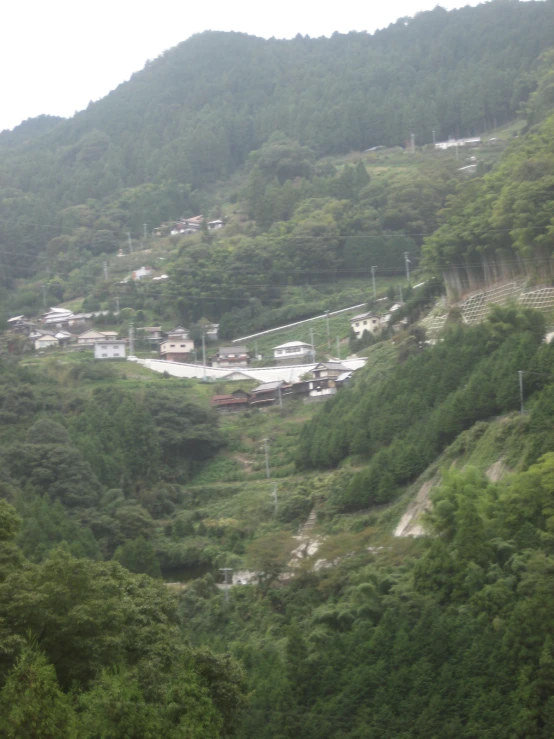 some houses on a slope next to a hill