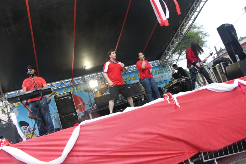 a group of people on stage playing musical instruments