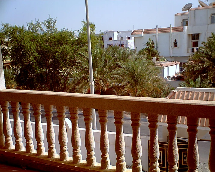 balcony with trees and street in background