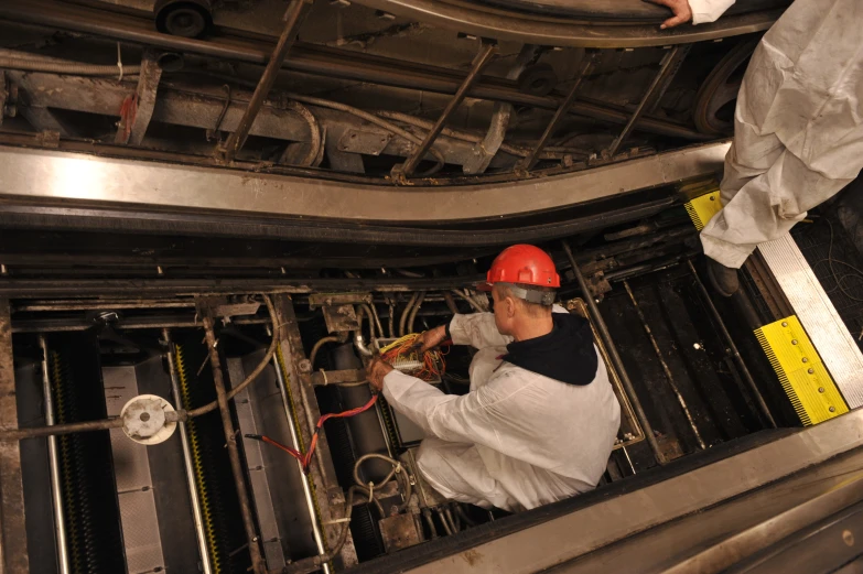 a worker adjusting some wiring in a steel shop