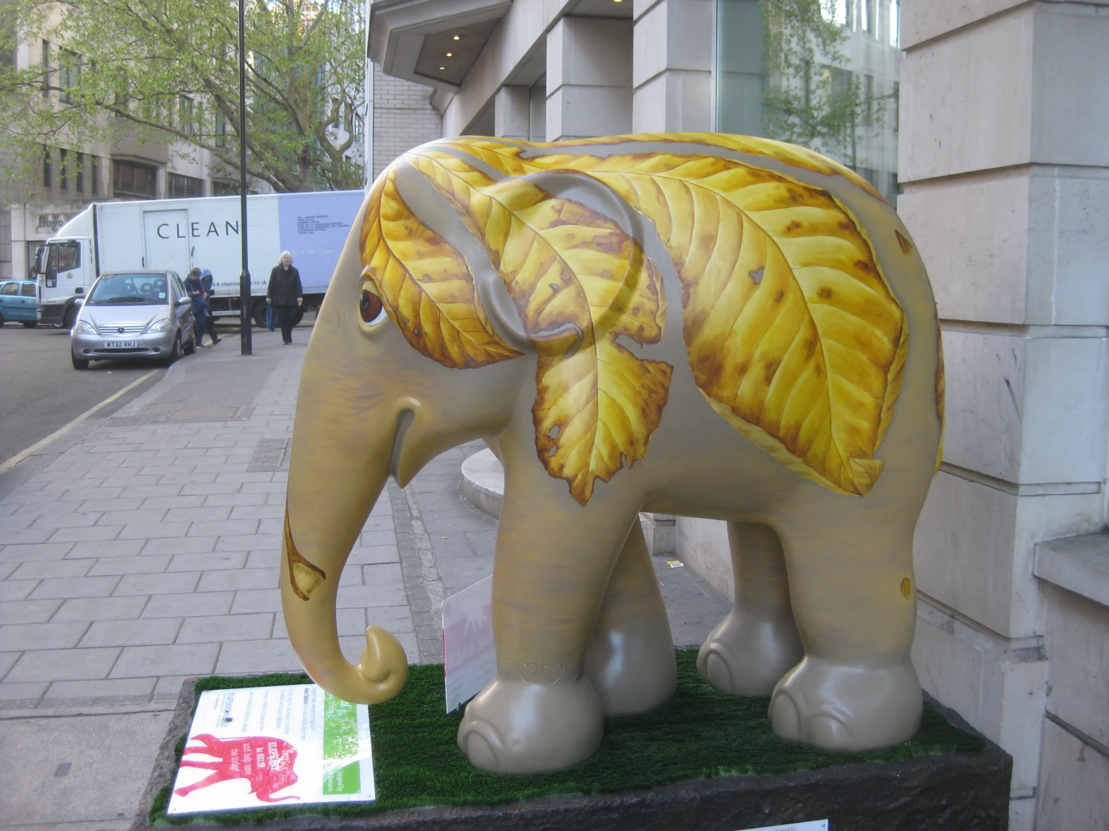 an elephant statue with leaves on the trunk