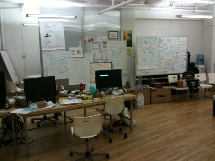 a classroom full of desks with chairs around them