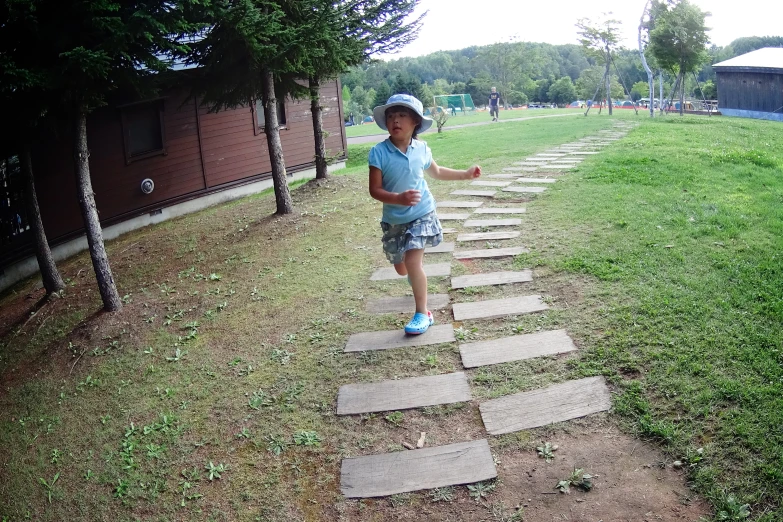 small boy playing with frisbee in a park