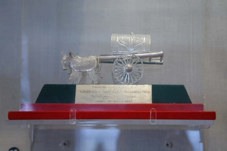 glass and metal display with a horse drawn carriage