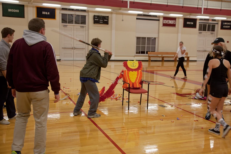 a couple of people in a gym with a chair