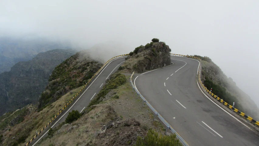 a mountain road with a mountain ridge in the background