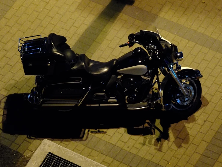 an upside down motorcycle sitting on tiled floor