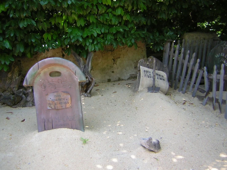 a beach area with an old looking bench and sign