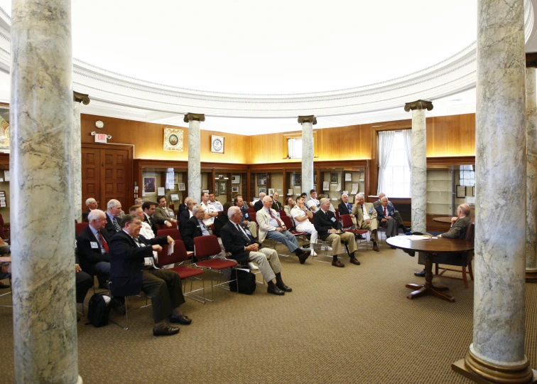 many people sitting down in a large room