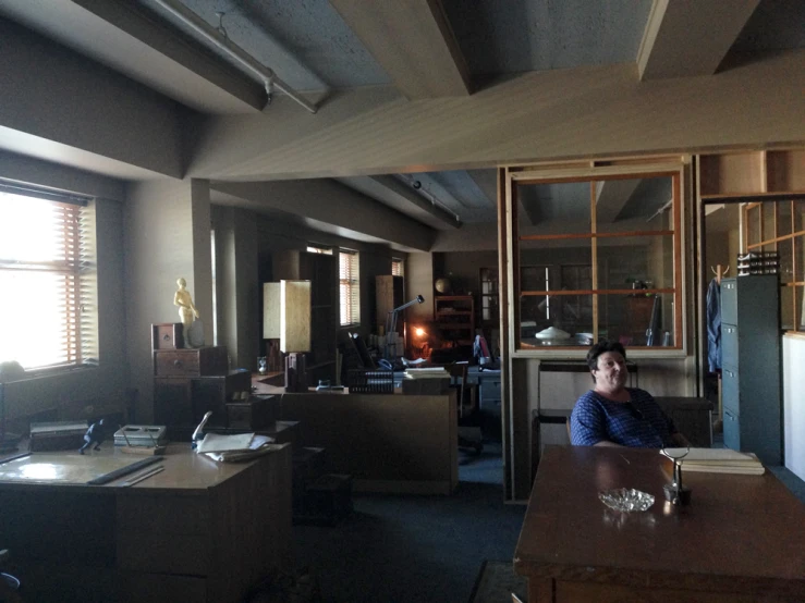 a woman sitting in a dimly lit office area