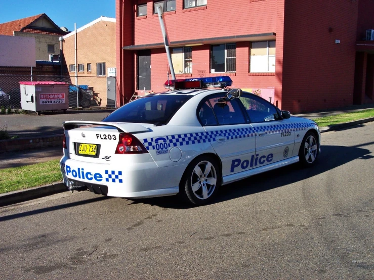 a police car parked in front of a building