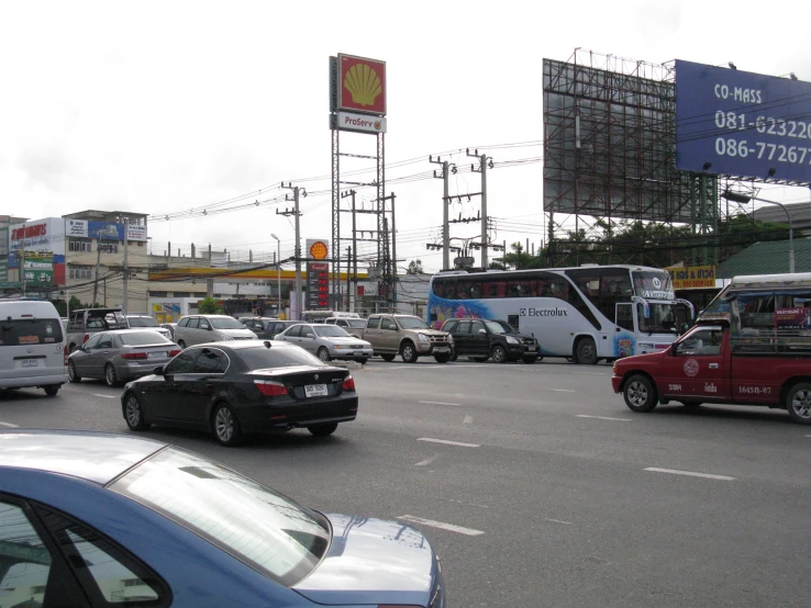 cars and buses traveling in opposite directions in an intersection