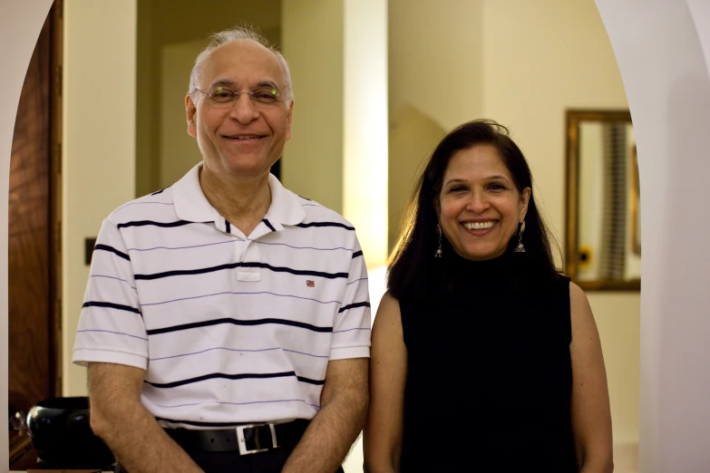 a man and woman standing in front of a doorway