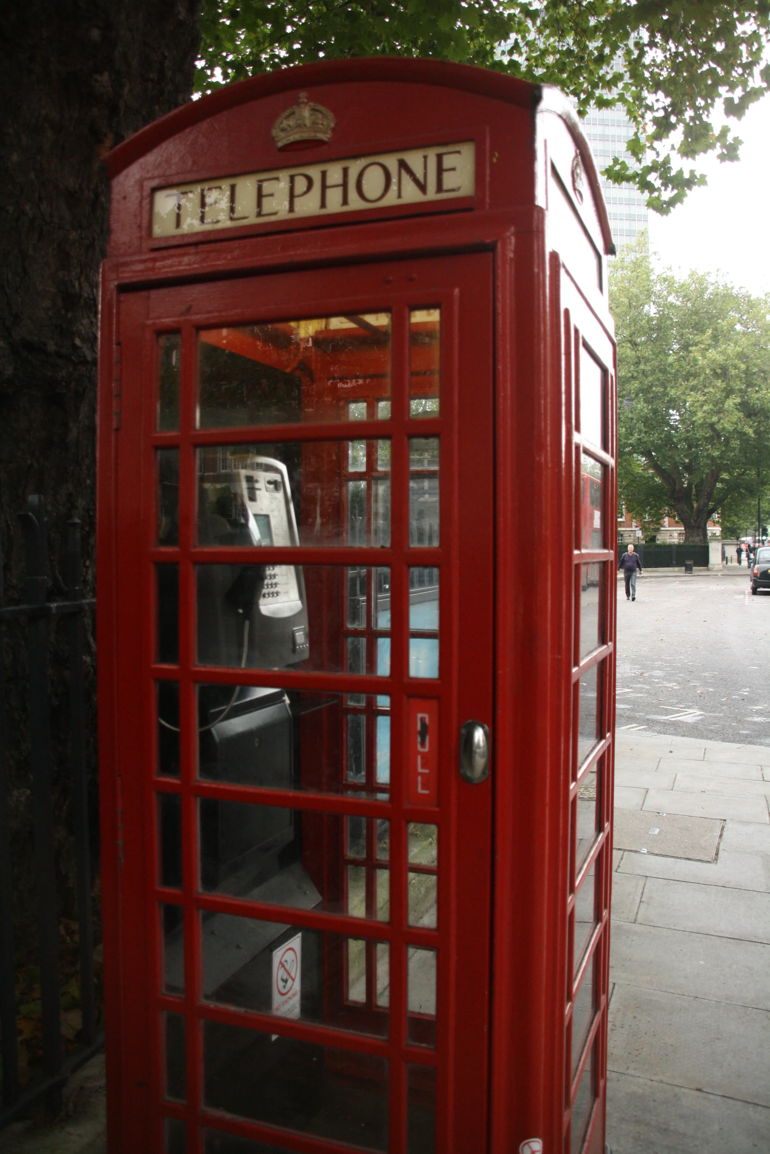 a red phone booth with some electronics inside