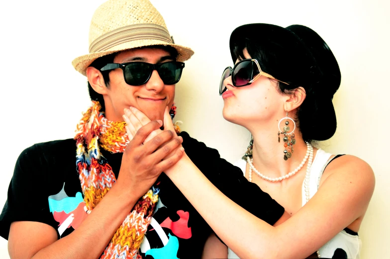 a couple wearing sun glasses and a hat