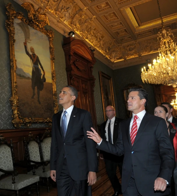 two men in suits in a palace room