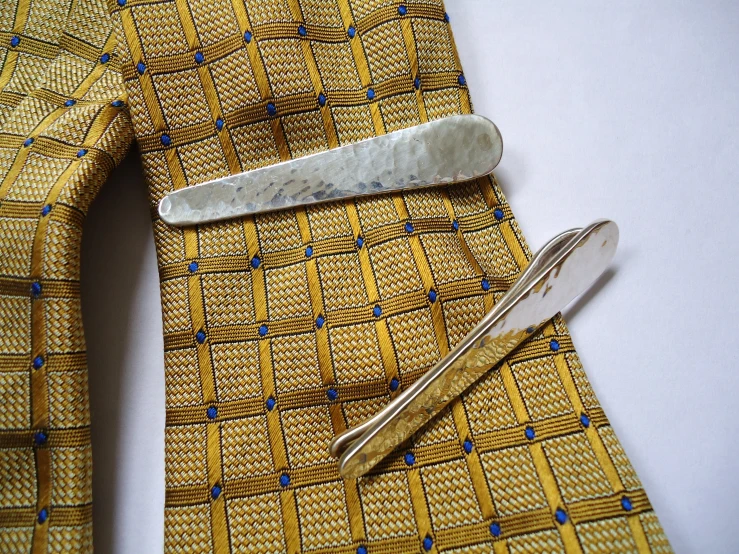 an image of a tie with scissors laying on it