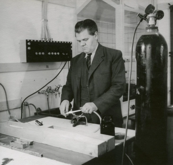 a man in a suit working on soing with a fire extinguisher