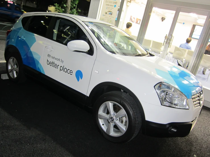 an electric car that is painted white and blue