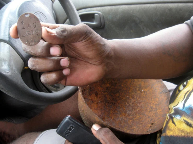 a close up of a person holding a disc in their hand