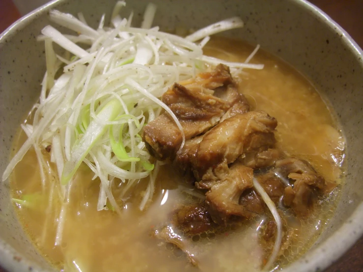 a bowl with noodle and chicken soup with rice