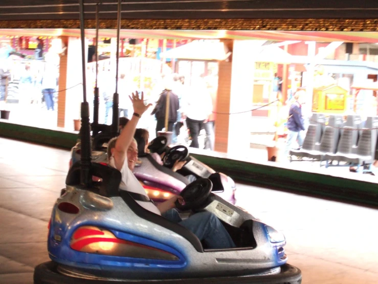 two children on bumper cars in a parking lot