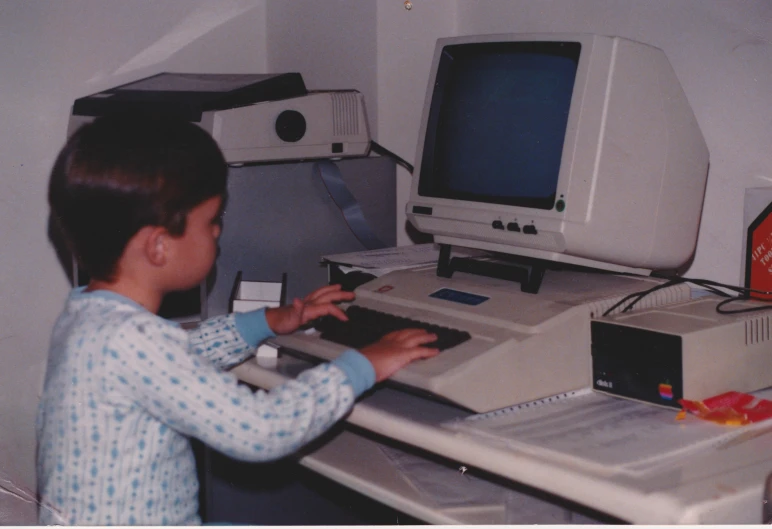 a child using a computer and playing with it