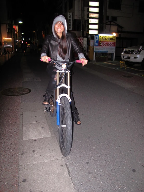 a woman is riding her bike down the street