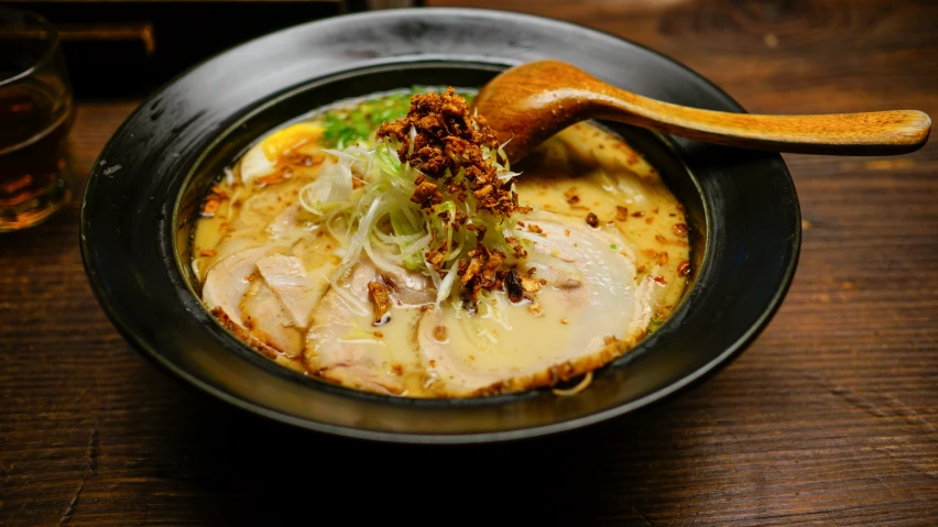 a bowl of noodles in an asian style soup