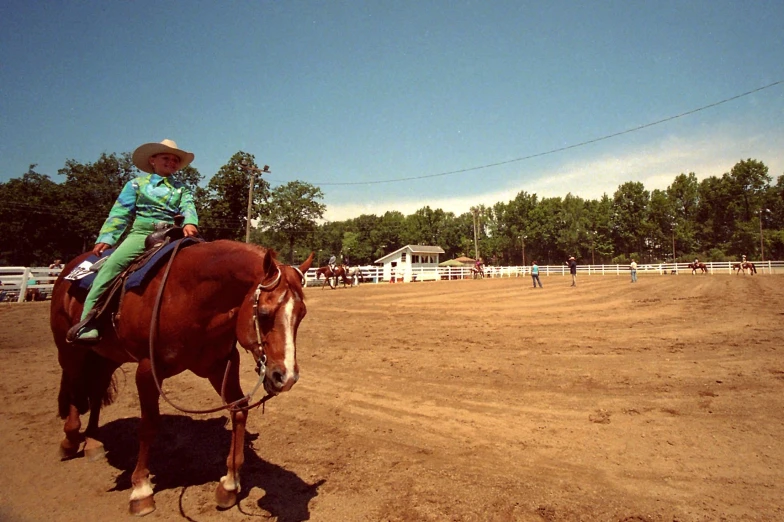 a woman on a horse in a dirt track