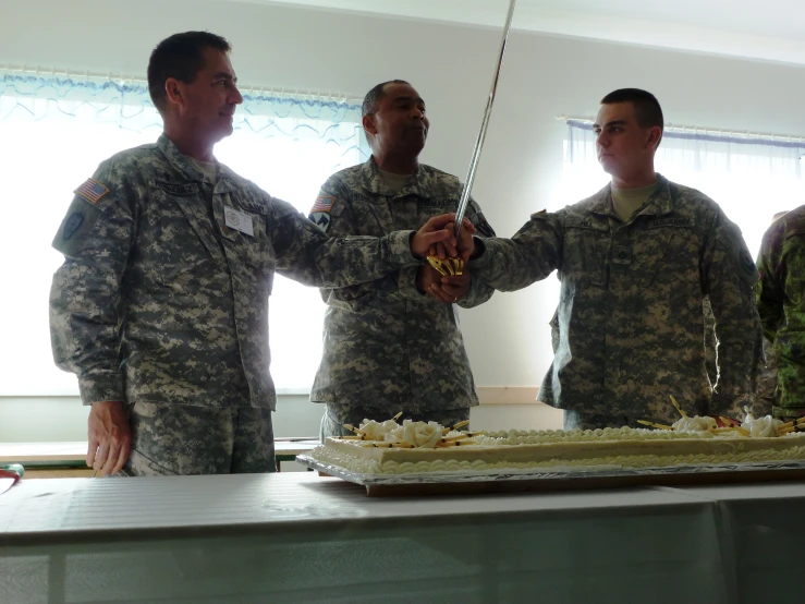 four soldiers standing in front of a cake