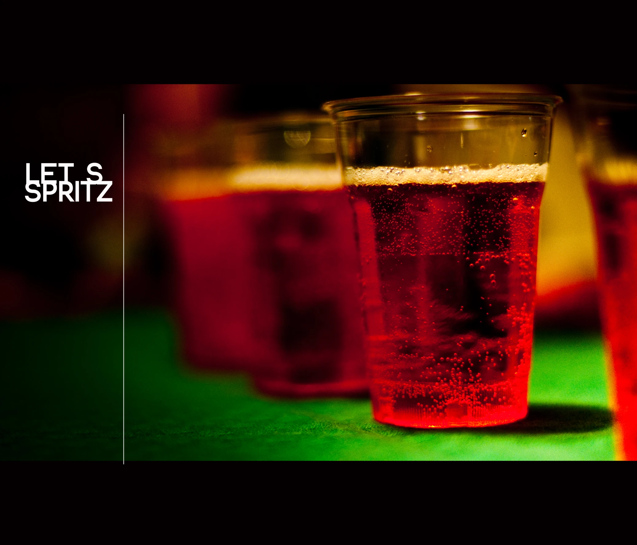 several glasses full of beer on a green table