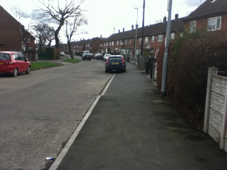 there is a line of cars that are parked along the street