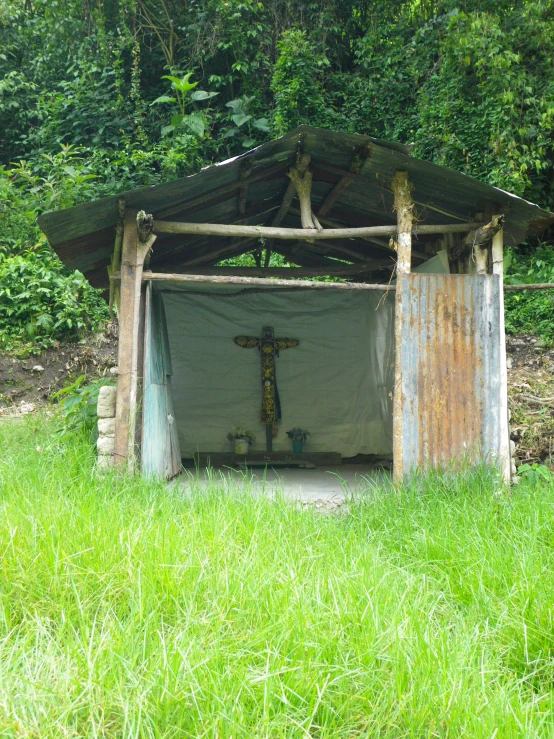 a wooden shed with a flag on top of it