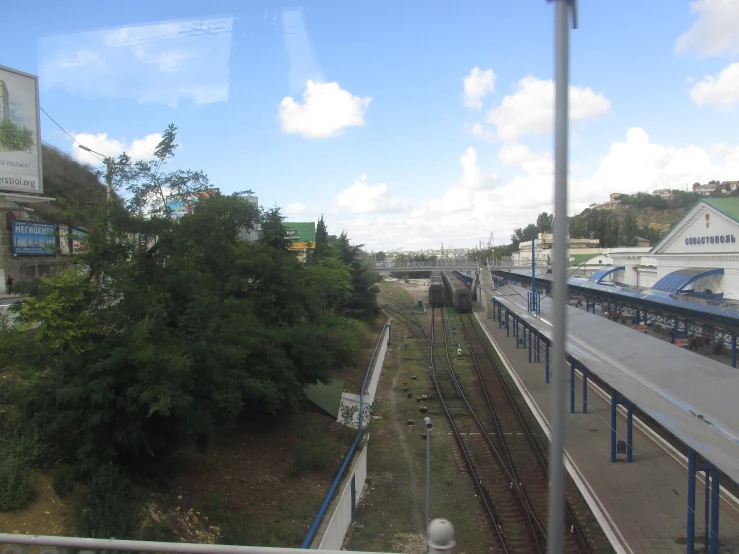 there are trees near the train tracks and building