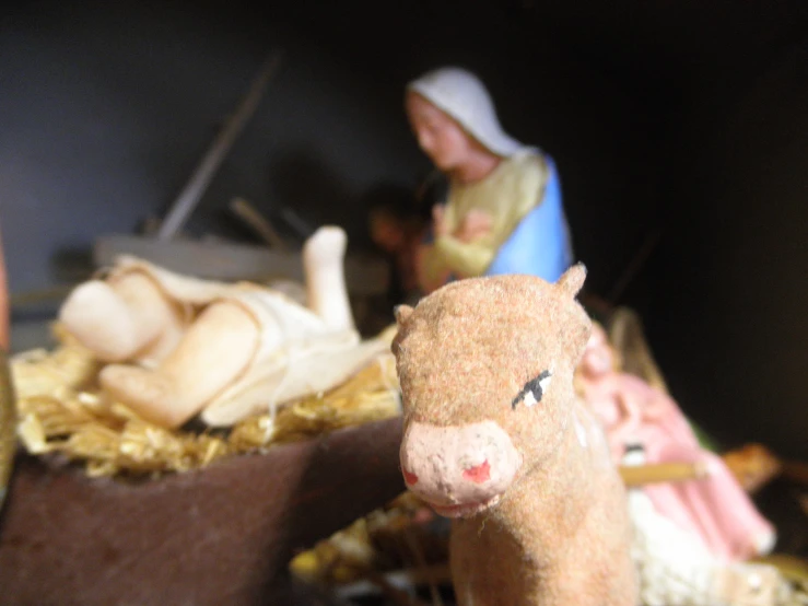 a small toy animal in a nativity scene